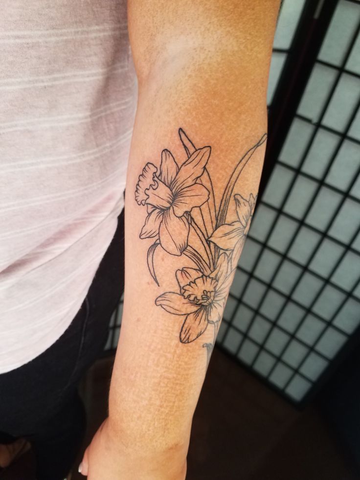 a person with a flower tattoo on their arm