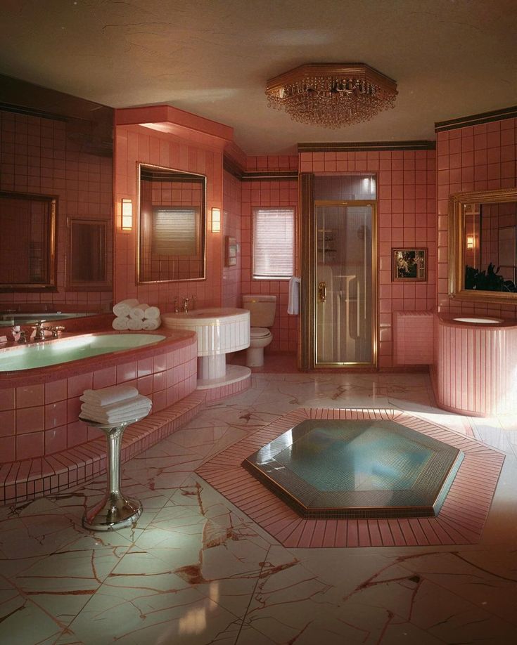 a large bathroom with pink tiles on the walls and floor, including a jacuzzi tub