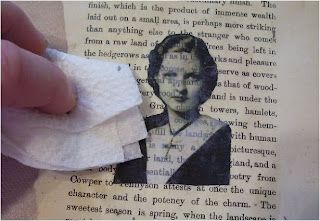 a person holding a piece of paper with the image of a woman on it