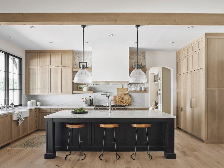 a large kitchen with wooden cabinets and stools