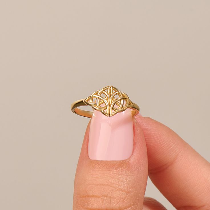 Elevate your style with our Celtic Knot Ring, a minimalist and timeless piece inspired by Irish and Viking heritage. Available in 14k, 18k, and 10k Solid Gold, this ring features a vintage-inspired Trinity braided knot design, capturing the essence of tradition and craftsmanship. Ring Details ❥ Gold KT: 14k 18k 10k Solid Gold ❥ Gold Color Options: White Gold, Yellow Gold, Rose Gold  ❥ Top Width: 8.90 mm ❥ Bottom Width: 1.90 mm ❥ Thickness: 1.40 mm ❥ Ready to Ship 4-7 Business Days MORE FROM US Statement Rings: https://etsy.me/3bb0QYW More about my shop: https://etsy.me/3mwMnsA ESSENTIAL INFORMATION 💎 BRENNMORE pieces are handcrafted by 15-30 years of experienced craftsmen and made to order. 🎁 All pieces come in a special turquoise gift box wrapped beautifully with a ribbon 🌎 All of our Adjustable Delicate 14k Gold Midi Rings, Elegant Stackable 14k Gold Hypoallergenic Rings, Elegant 14k Gold Hypoallergenic Stackable Rings, Classic Adjustable 14k Gold Midi Rings, Elegant Hypoallergenic 14k Gold Stackable Rings, Timeless Adjustable Midi Rings For Promise, Timeless Adjustable Midi Rings As Gift, Timeless Style Adjustable Midi Promise Rings, Adjustable Modern Initial Ring In 14k Gold