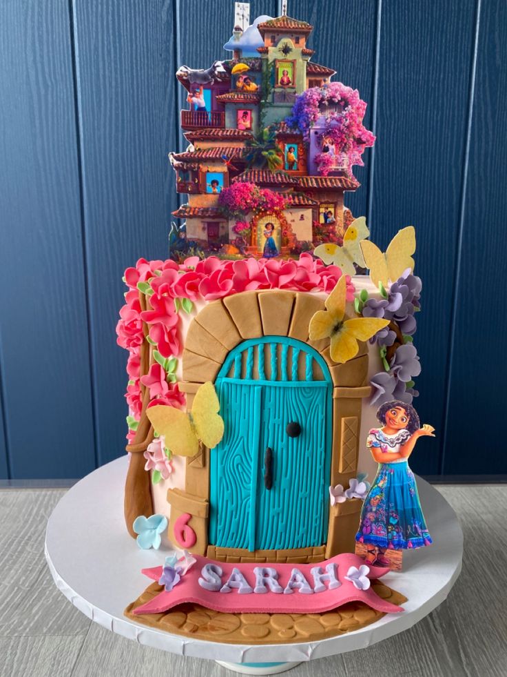 a birthday cake with an image of a fairy tale on it's front door