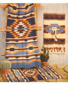 two rugs and a cactus in front of a wall hanging on a wooden frame