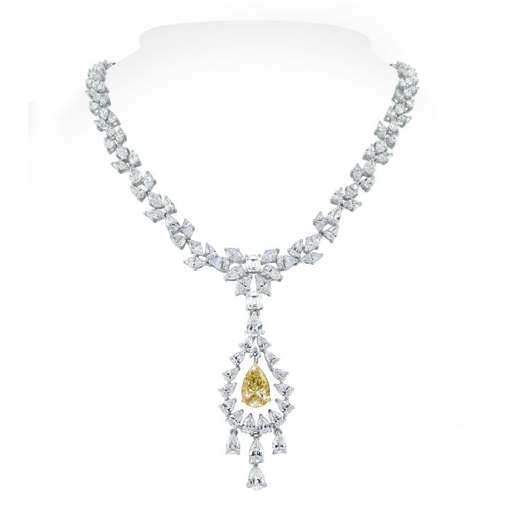 With a yellow pear shape diamond at its center, the Amaya necklace is all about delicacy and oomph. The marquise and pear diamonds weaving around the neck are elegant and sensual. This stunning piece can be worn with or without the pendant to add to its versatility and allure. Diamonds Shapes: Pear Shape, Marquise, Emerald & Round Center Solitaire: 2.60 ct Fancy Yellow Pear ShapeTotal Diamonds Weight: 22.45 ctDiamonds Color: G - H Diamonds Clarity: VS - SI (Very Slightly Included - Slightly Incl Marquise Diamond Pendant, Marquise Diamond Necklace, Yellow Diamond Jewelry, Yellow Diamond Necklace, Bridal Diamond Necklace, Diamond Weave, Diamond Jewelry Designs, Expensive Jewelry, Fancy Jewelry