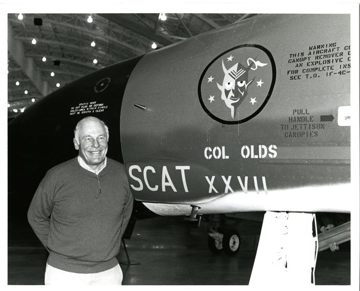 a man standing in front of an airplane with the name scott xxvii on it