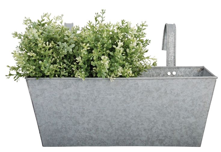 a metal planter with green plants in it