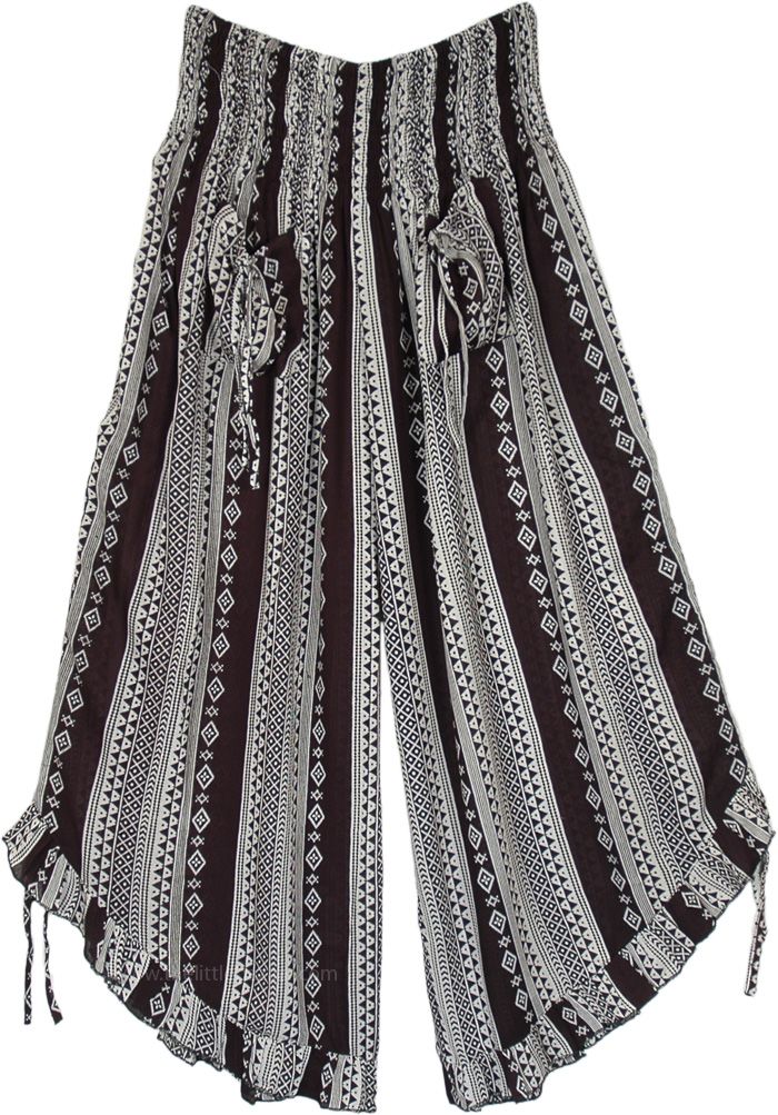 A gaucho style cropped wide-leg pants featuring a smocked elastic waistband, two front tie-up pockets, and ruffle leg opening with tie-ups at the bottom - this flared hemline can be pulled to make the leg opening higher.  These black and white culotte pants have a tribal style pattern which gives them a modern classic bohemian look. #tlb #SplitSkirtsPants #Pocket #SmockedWaistPants #RayonCapri #GauchoPants Bohemian Wide-leg Pants With Drawstring, Bohemian Drawstring Trousers, Bohemian Wide-leg Drawstring Pants, Summer Drawstring Wide-leg Harem Pants, Summer Wide-leg Harem Pants With Drawstring, Wide Leg Bottoms With Tassels, Bohemian Bottoms With Drawstring Tie-side, Bohemian Tie-side Bottoms With Drawstring, Bohemian Wide Leg Bottoms With Drawstring