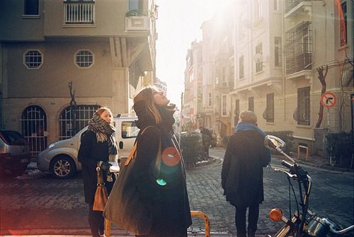 two people walking down a street next to parked cars and bicycles with the caption be so busy that you have no time to bead