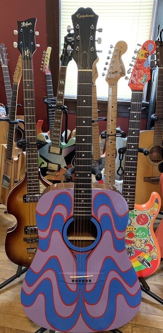 several guitars are lined up in a room