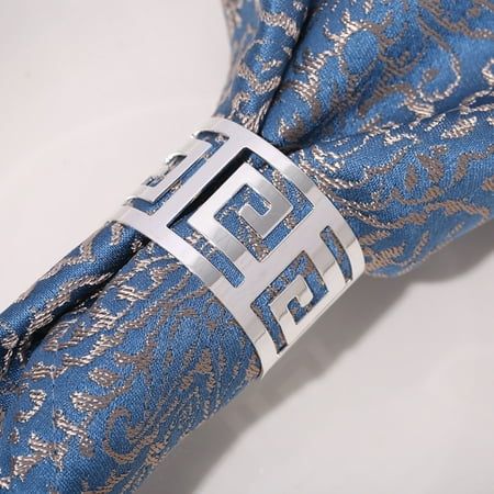 a blue and gold patterned umbrella with silver metal accents on the top, in front of a white background