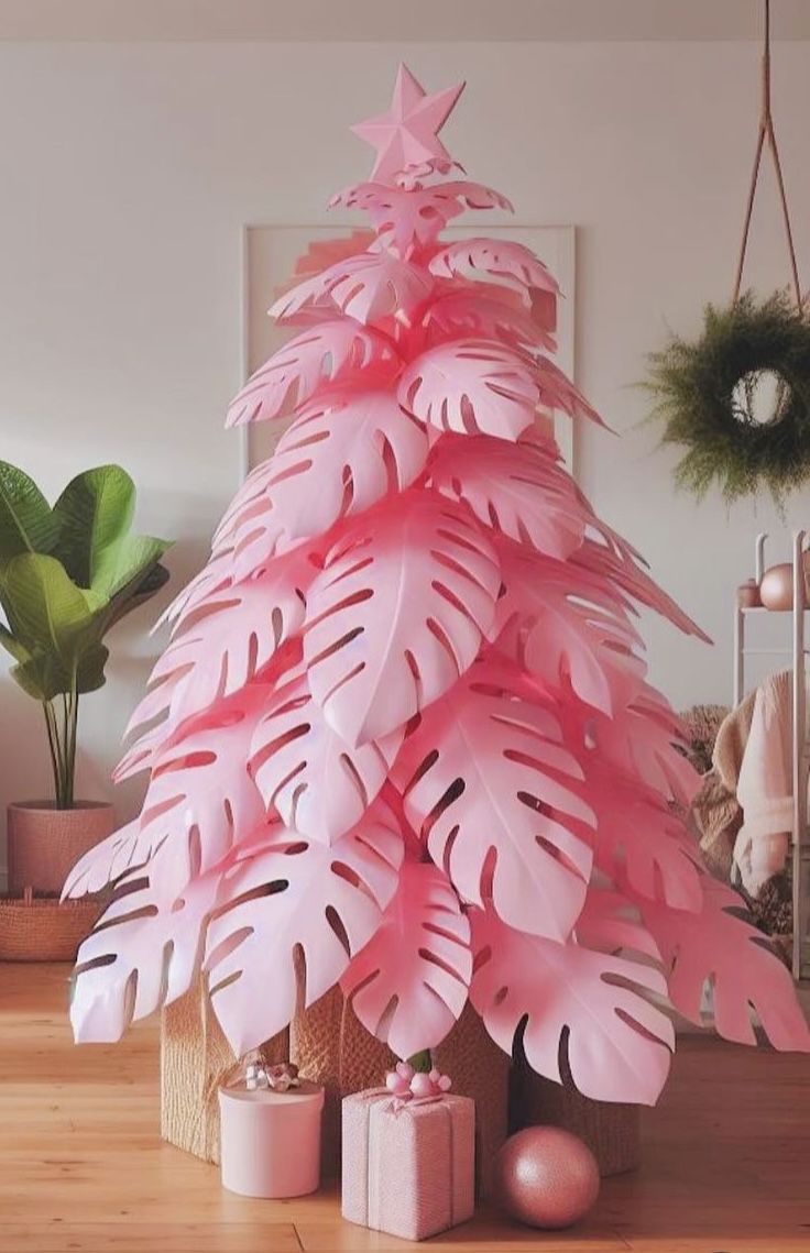 a pink christmas tree decorated with paper leaves