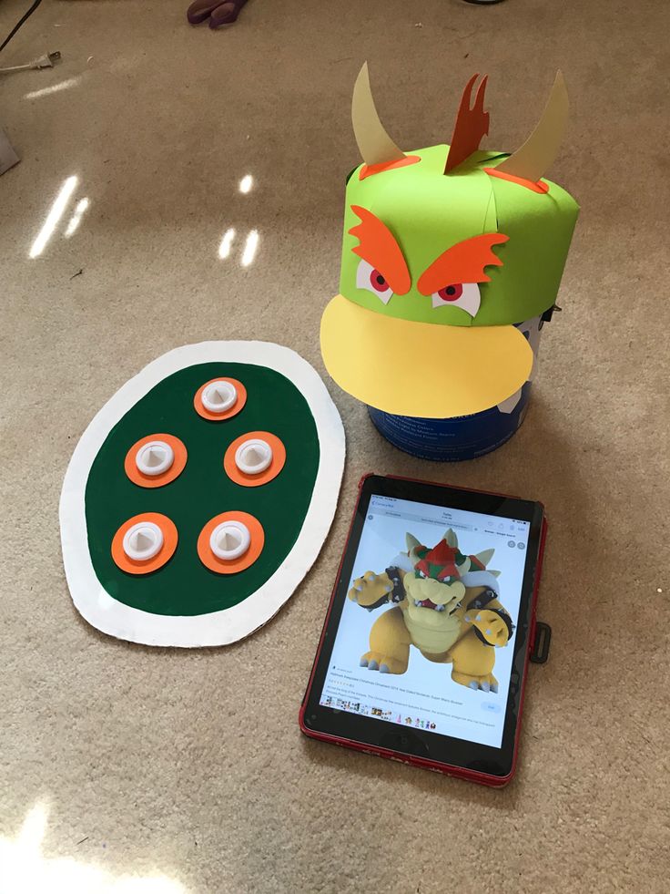 a tablet and some paper toys on a table