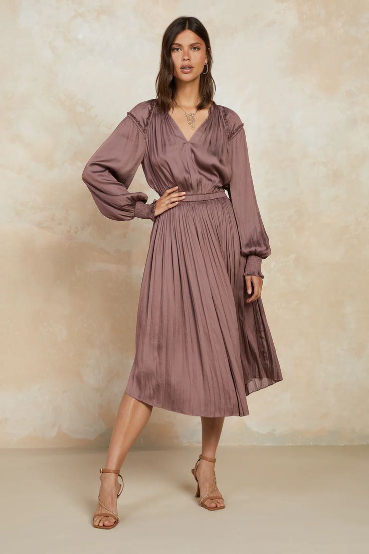 Just a few reasons to adore this V-neck midi dress: ruffled shoulder panels, billowy long sleeves, and the way all those pleats flow to a slightly asymmetrical hem. So pretty. •Relaxed fit •V-neck •Ruffled shoulder panels •Long sleeves with smocked cuffs •Elasticized waist •Pleated •Asymmetrical hem •Relaxed fit DIMENS Mauve Outfit, Midi Dress Fall, Mauve Dress, Flowing Dresses, V Neck Midi Dress, Asymmetrical Hem, Asymmetric Hem, Satin Dresses, So Pretty