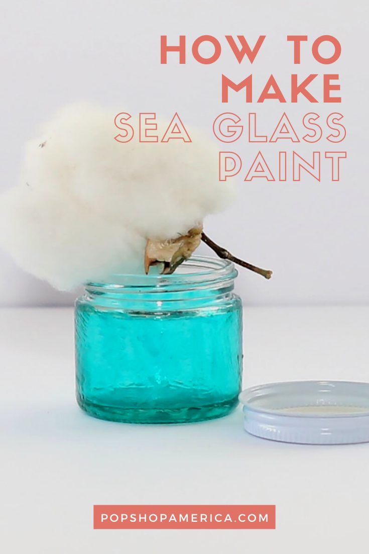 a glass jar filled with sea glass paint and cotton floss on top of it