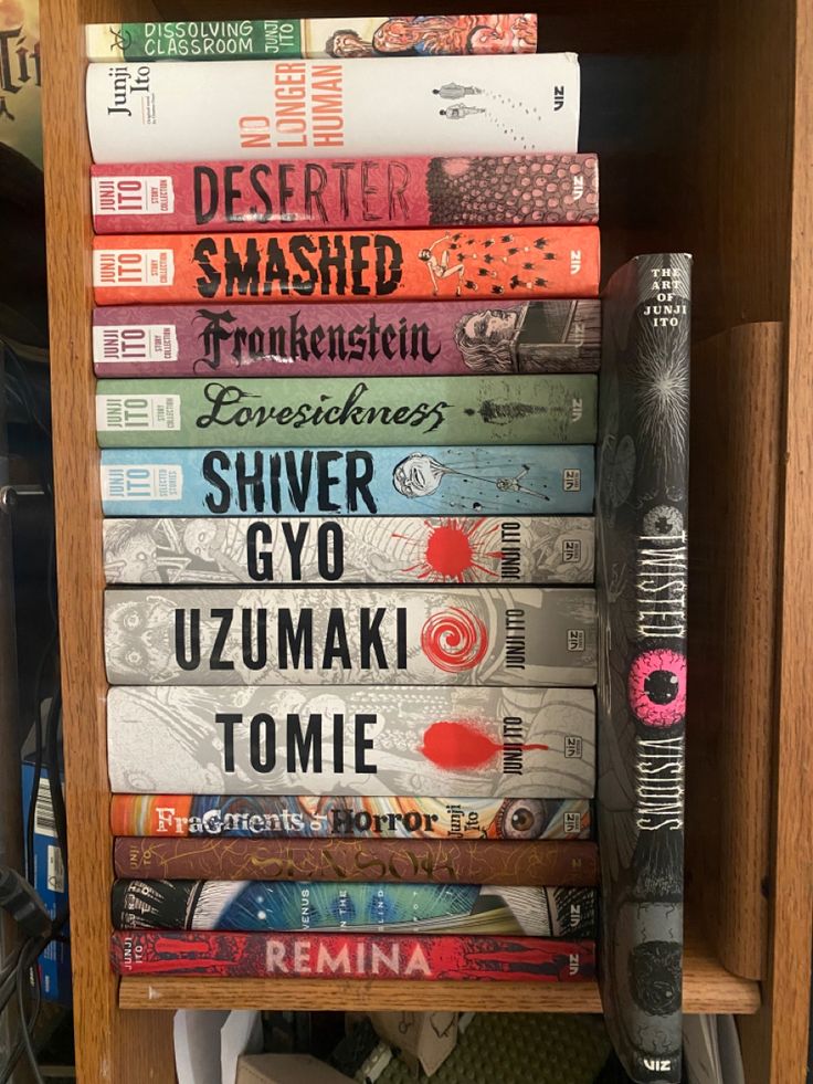 a stack of books sitting on top of a wooden shelf