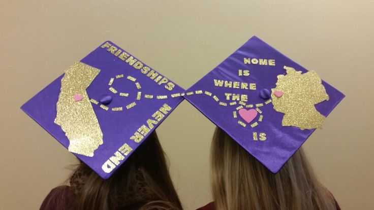 two girls wearing purple and gold graduation caps with the words home is where the heart is