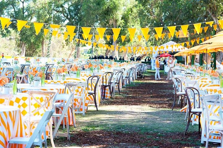 tables and chairs are set up under yellow flags