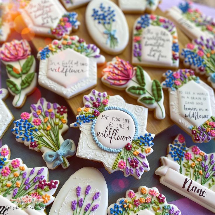 decorated cookies with flowers and words on them