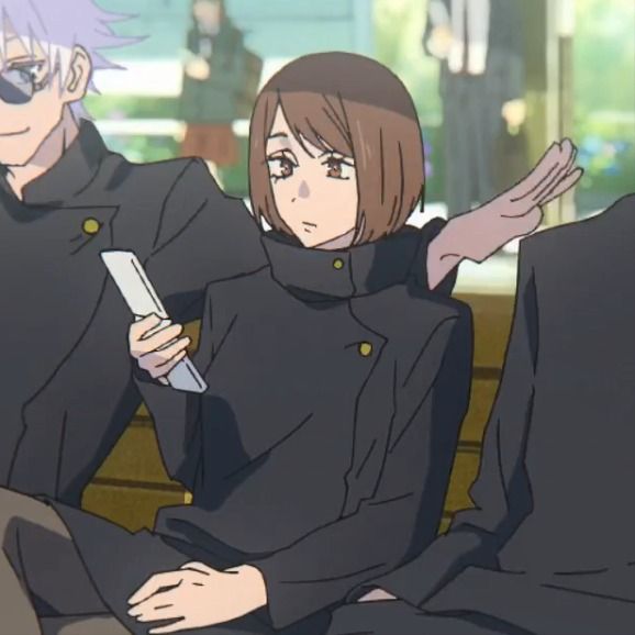 two anime characters sitting on a bench with one holding a cell phone in his hand