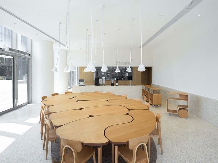 a large wooden table surrounded by chairs in a room