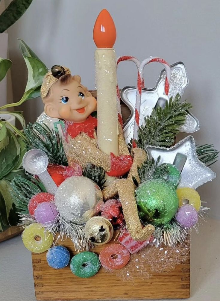 a basket filled with christmas decorations and a candle