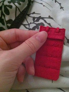 a hand holding a small red piece of fabric