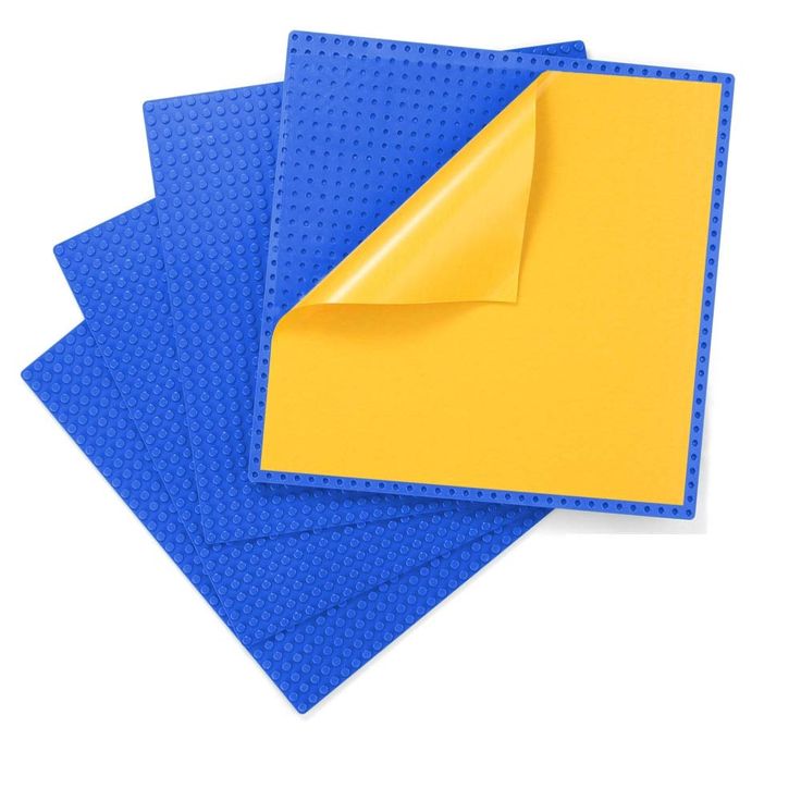 blue and yellow placemats on top of each other, with one folded up in the middle