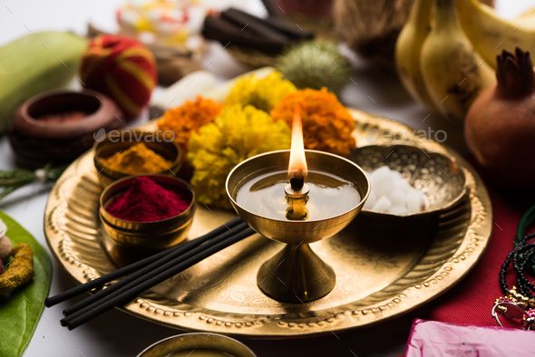 an assortment of different types of food on a plate with candles and other items around it