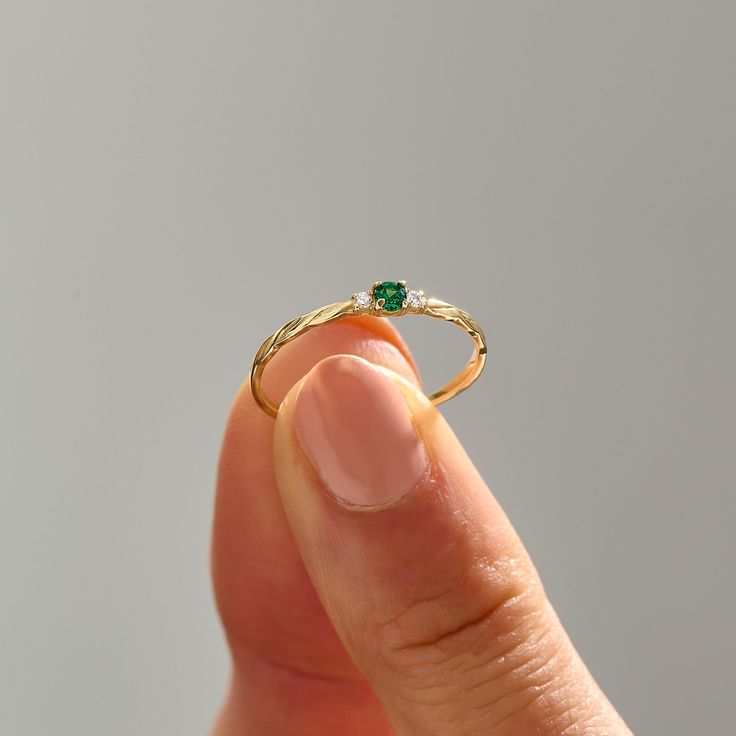 Elevate your style with this Emerald Minimal Solitaire Ring by Lucy Jewelry. Crafted in 14k solid gold, it features a dainty twisted band that leads to a brilliant emerald solitaire. This ring exudes elegance and sophistication, making it an ideal choice for a promise ring, engagement ring, or a unique addition to your jewelry collection. The ring can be made with yellow, rose, or white gold, please choose your size from the dropdown menu options above. 𝐑𝐢𝐧𝐠 𝐃𝐞𝐭𝐚𝐢𝐥𝐬 ❥ Solid gold, avai Stackable Yellow Gold Emerald Ring For Promise, Adjustable 14k Gold Emerald Ring, Yellow Gold Stackable Emerald Ring For Promise, 14k Gold Emerald Ring For Promise, May Birthstone, 14k Gold Emerald Promise Ring, May Birthstone, 14k Yellow Gold Emerald Ring For Promise, 14k Gold Emerald Birthstone Ring, Fine Jewelry Birthstone Ring In Recycled Gold, 14k Gold Green Diamond Cut Ring