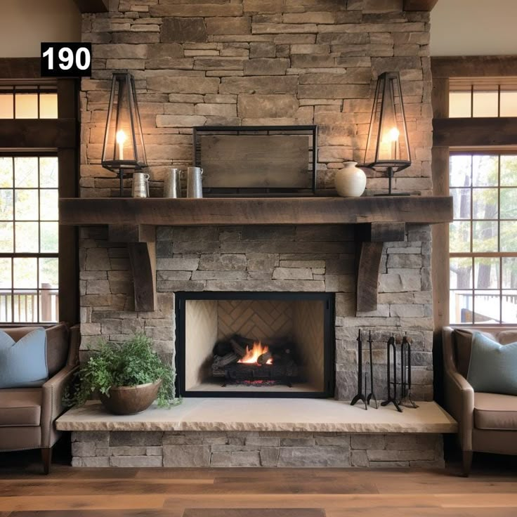 a living room with a fire place and couches in front of the stone fireplace