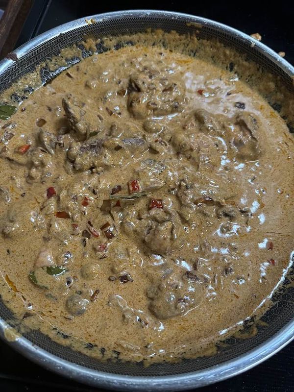 a metal pan filled with food on top of a stove