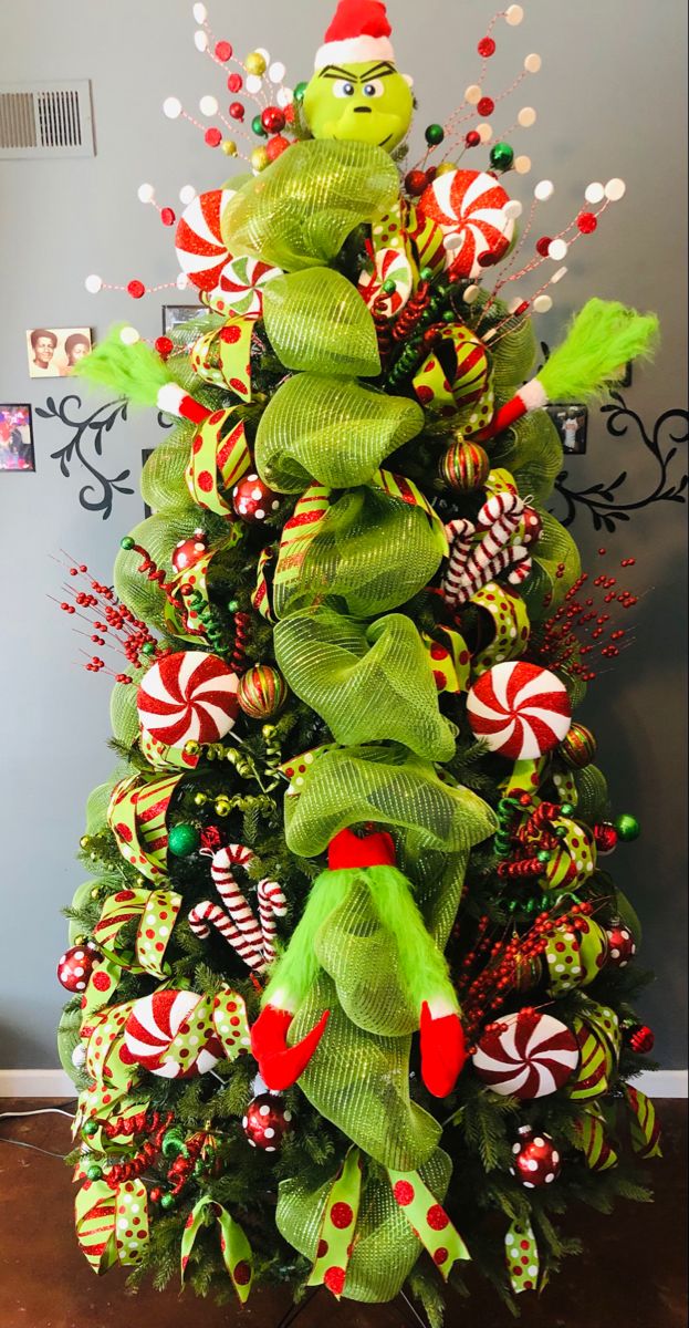 a christmas tree decorated with green and red candy canes