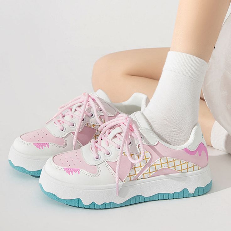 These sneakers feature a playful ice cream-inspired design with pastel colors arranged in a grid pattern, highlighted by whimsical drips and wavy soles for a fun and youthful look. Material: Vegan Leather Run small, please review the sizing information Trendy Pink Chunky Sneakers With Rubber Sole, Pastel Sneakers With Rubber Sole For Streetwear, Playful Sneakers With Rubber Sole And Synthetic Material, Playful Synthetic Sneakers With Rubber Sole, Pink Casual Chunky Sneakers With Rubber Sole, Cute Multicolor Low-top Sneakers, Pink High-top Chunky Sneakers With Vulcanized Sole, Casual Pink Chunky Sneakers With Rubber Sole, Playful Lace-up Sneakers For Sports