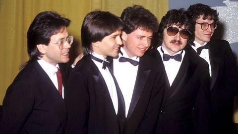 a group of men in tuxedos standing next to each other