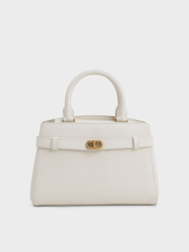 Contemporary style meets city glamour. You can always rely on our Aubrielle top handle bag for a natural flavour of elegance. We decided to spruce it up with a bit of modern flair and added a belt at the front decorated with a gold-tone metallic-accent that lights up the overall design. With the captivating cream colour to finish it off, this one is definitely a keeper. Style it with a linen playsuit and strappy sandals for a casually graceful look. Linen Playsuit, Birkin Mom, Charles And Keith, Aesthetic Dress, Buckle Top, Size Chart For Kids, Cream Colour, Charles Keith, Cherry On Top