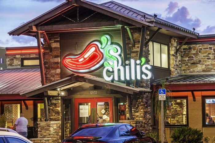 a restaurant with cars parked in front of it and the sign for chili's