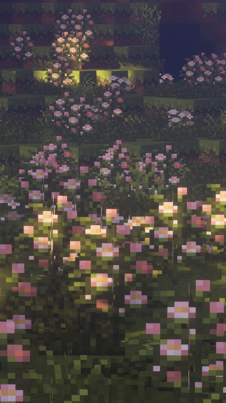 a field full of pink flowers next to a forest