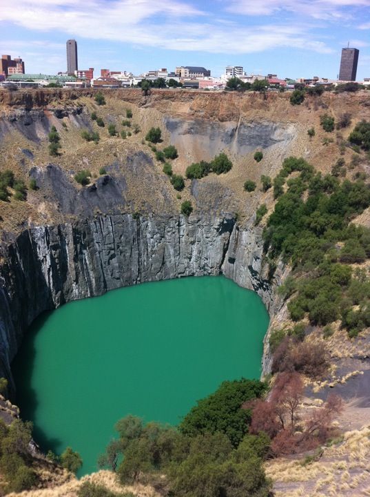 an aerial view of a lake surrounded by trees