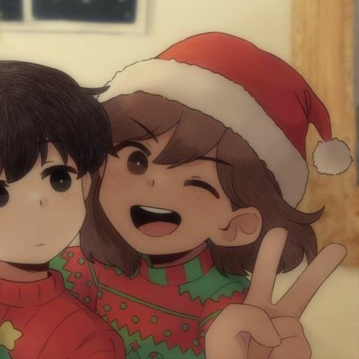 two children wearing christmas hats and pointing at the camera