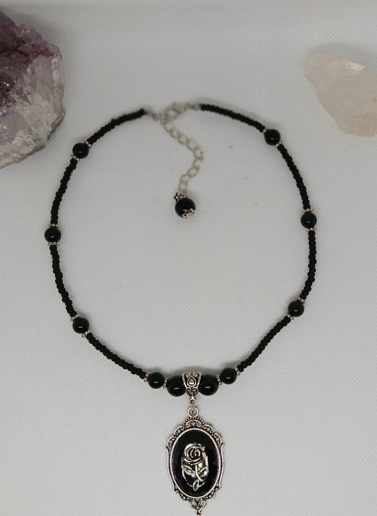 Black obsidian  necklace with rose charm Black Beaded Necklaces With Round Pendant As Gift, Black Beaded Necklace With Round Pendant For Gift, Handmade Black Charm Necklace With Round Pendant, Black Choker With Lobster Clasp As Gift, Black Beaded Pendant Crystal Necklace, Adjustable Black Spiritual Charm Necklaces, Black Adjustable Spiritual Charm Necklace, Obsidian Necklace With Round Black Beads, Black Spiritual Choker Necklace