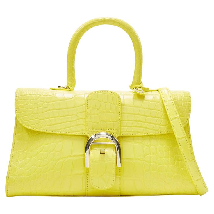 rare DELVAUX Brilliant PM Sunshine Citron yellow scaled leather crossbody bag Reference: KNLM/A00237 Brand: Delvaux Model: Brilliant E/W PM Material: Leather, Blend Color: Yellow, Silver Pattern: Solid Closure: Buckle Lining: Leather Extra Details: Genuine croc in Sunshine yellow. Brilliant E/W PM bag. Single top handle. Silver-tone hardware. Signature buckle flap closure. Detachable adjustable shoulder strap. Metal ball stud feet at base. Made in: Belgium CONDITION: Condition: Excellent, this i Bag Reference, Vintage Evening Bags, Micro Bag, Gold Aviator Sunglasses, Sunglasses Logo, Crossbody Satchel, Crossbody Bag Women, Yellow Leather, Satchel Bag