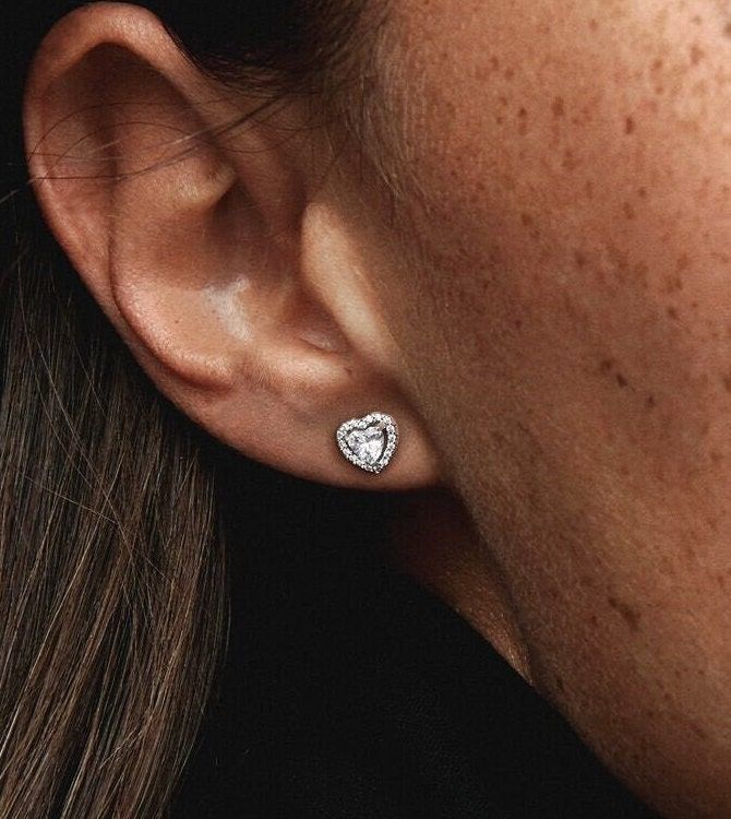 Featuring: Heart Shaped Stud Earring. The sparkling ear studs are a classic style that will be treasured for years to come thanks to its sophisticated, yet simple design.  Stones: CZ Stones Finish: Silver  Nickel free, Lead Free, Hypoallergenic. Anti Tarnish. ♡ The perfect gift for you or your loved ones ♡ T U R N ∙ A R O U N D ∙ T I M E   Ready to ship in 1 - 2 business days.  S H I P P I N G - Ships from the US to ensure quality, reliability, and punctuality. - All orders will be shipped out the same day or the next business day after the order has been received.  - We ship USPS for US buyers. It normally takes 2-4 business days to be delivered after dispatch. It includes tracking. However due to the current uncertainty, there may be delays with Delivery Companies. SHIPPING ADDRESS - All Pandora Earrings Studs, Pandora Rose Gold, Pandora Earrings, Pandora Rose, Pandora Heart, Antique Jewelry Box, Halo Earrings Studs, Circle Earrings Studs, Cz Jewelry