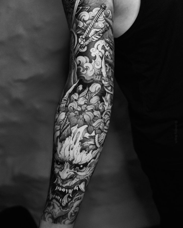 a man with a full sleeve tattoo on his arm