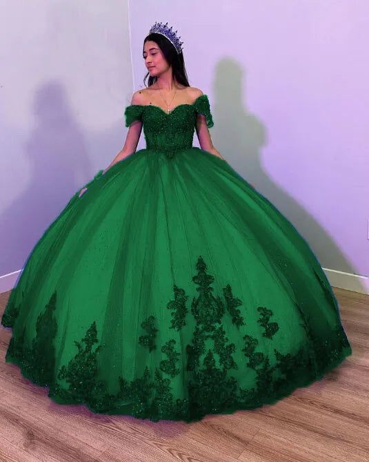 Step into your dream Quinceanera with the Fiora Ball Gown. This exquisite gown features a classic ball gown silhouette, beautifully crafted from layers of luxurious tulle fabric that add volume and movement to your every step. It is available in vibrant colors like royal blue, red, pink, purple, and green. The lace-up back ensures a perfect fit, accentuating your figure while adding a touch of classic charm. The intricate applique details and delicate beading sparkle with every turn, making you Princess Style Quinceanera Ball Gown For Gala, Ball Gown Quinceanera Dress For Prom Season, Green Evening Dress For Quinceanera And Prom Season, Organza Ball Gown For Sweet 16 And Prom Season, Organza Ball Gown For Sweet 16 Prom, Organza Ball Gown For Sweet 16 During Prom Season, Elegant Sweet 16 Ball Gown, Green Ball Gown Quinceanera Dress For Prom Season, Green Ball Gown For Prom Season Quinceanera