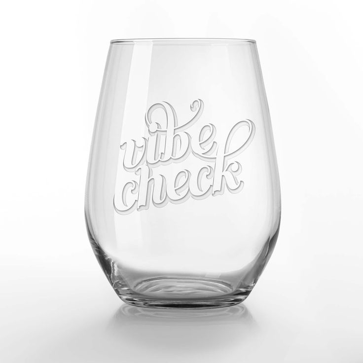 a wine glass with the words vibe check written in cursive writing on it