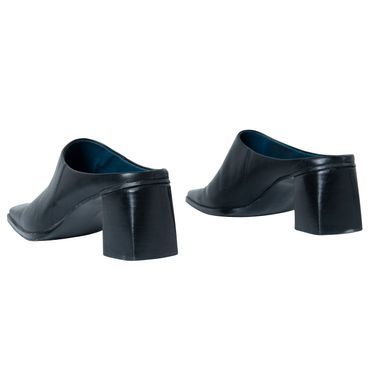 Features pointed toe and wide heel design Pointed Toe Mules With 4-inch Heel For Work, Sleek Pointed Toe Mules With Deep Heel Cup, Chic Pointed Toe Mules For Business, Business Mules With Sculpted Heel And Pointed Toe, Sleek Pointed Toe Mules With Padded Heel, Sleek Closed Toe Mules With Sculpted Heel, Workwear Mules With 4-inch Block Heel, Sleek Mules With Sculpted Heel And Almond Toe, Pointed Toe Mules For Business In Spring