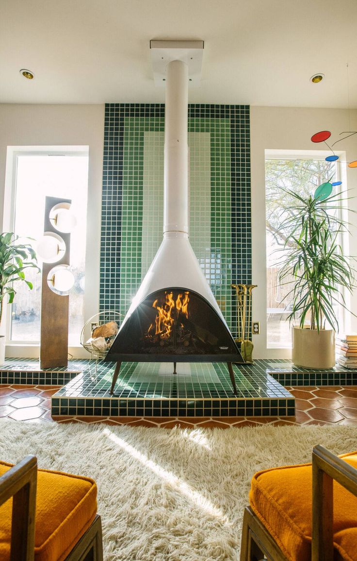 a living room filled with furniture and a fire place in the middle of the room