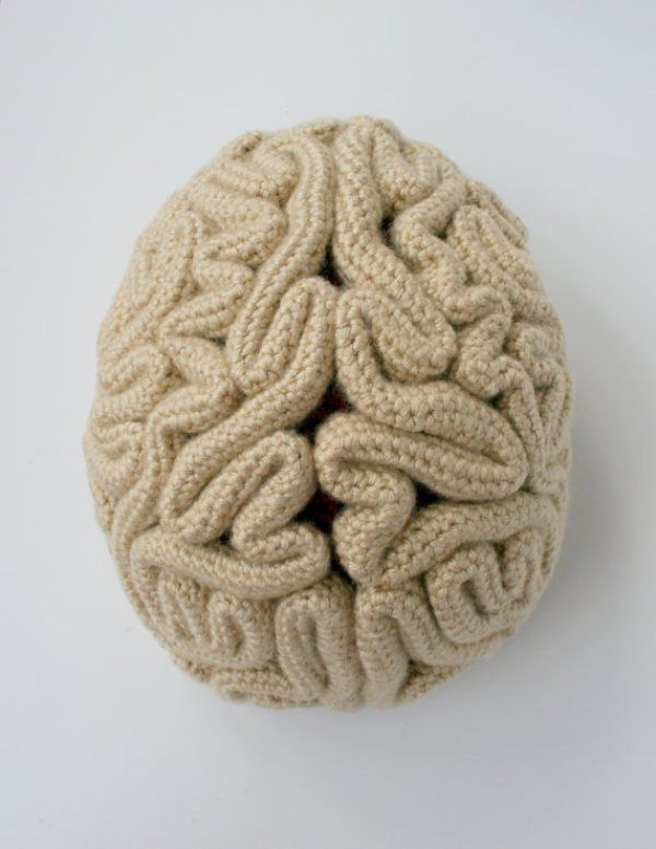 a knitted ball sitting on top of a white table