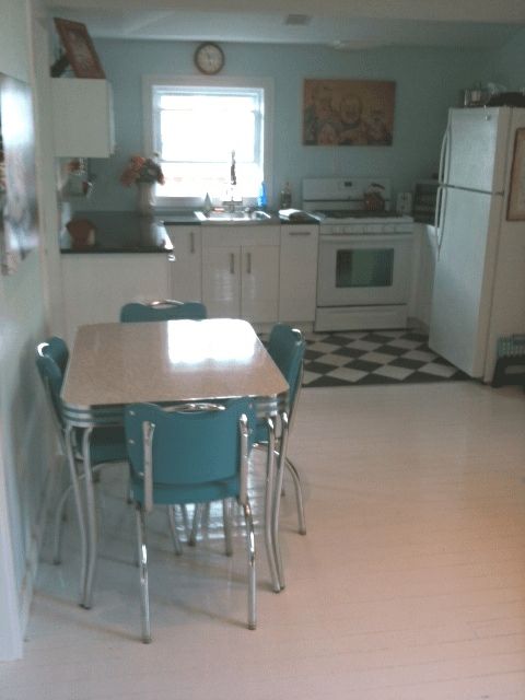 a kitchen with a table and chairs in it