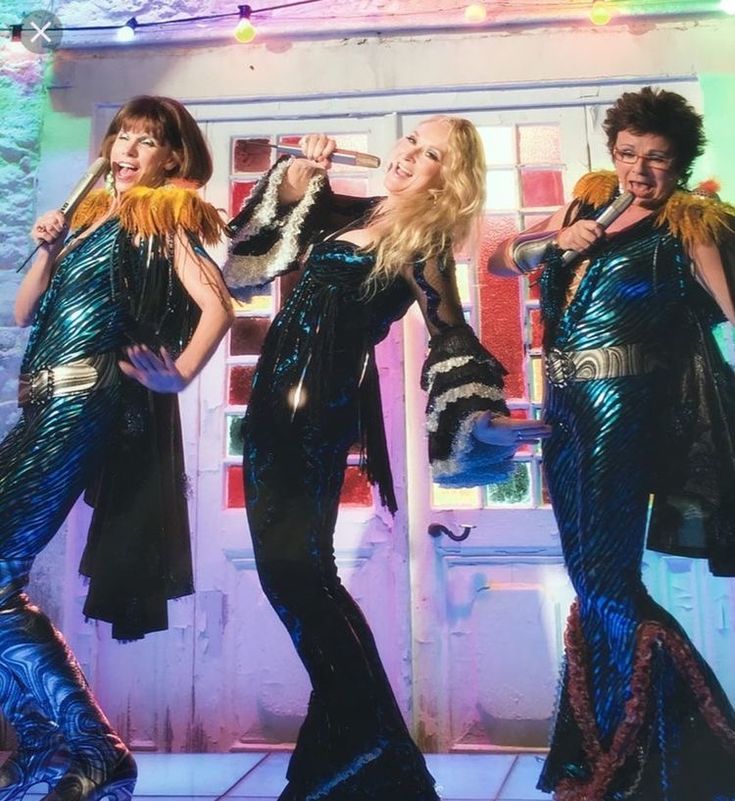 three women in sequins are posing for the camera